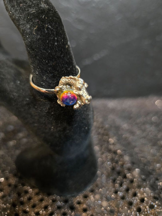 Silver Dragon holding globe.