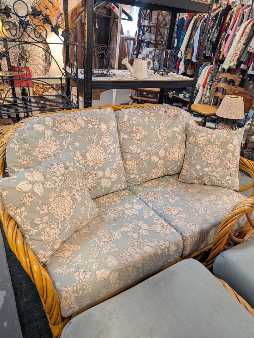 Rattan Couch with Floral Cushions