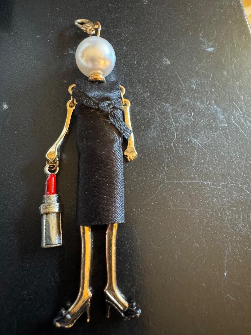 Woman in LBD holding wine bottlependant