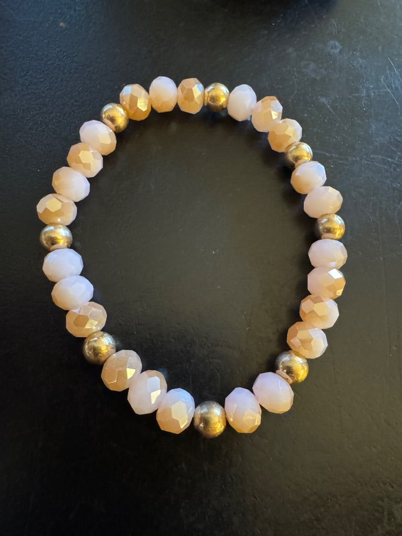 Faceted pink and gold tone bead stretchy bracelet