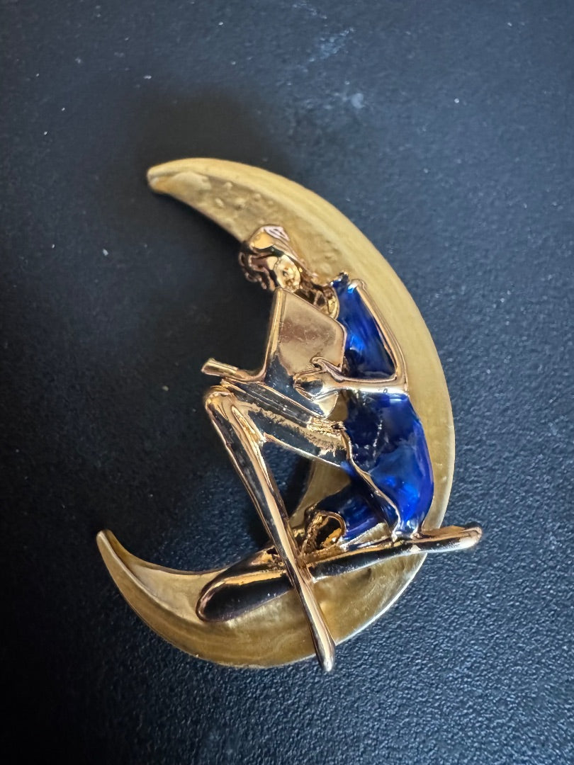 Women in blue dress on moon brooch