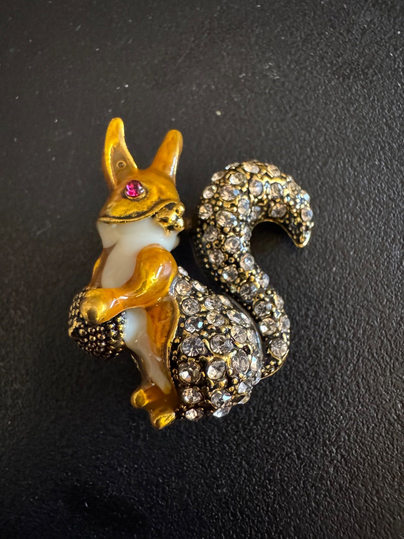 Squirrel holding acorn top brooch