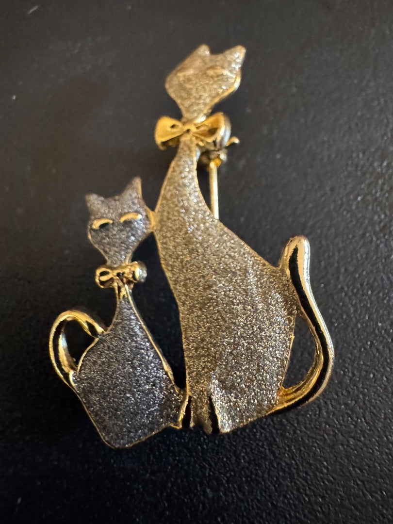 Two cats wearing bow ties brooch