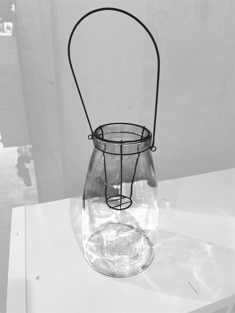Vintage style glass candle lantern with a black metal wire handle