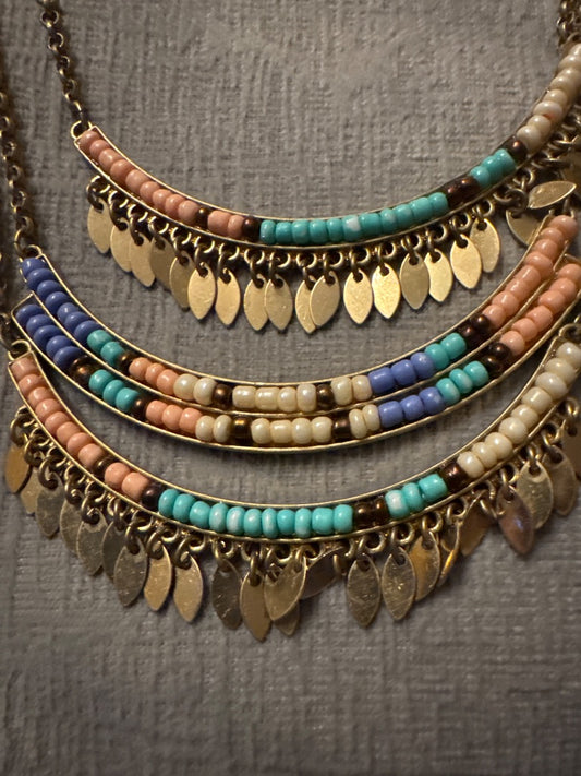 Gold tone setting, pastel beads Unknown Three bar, long, gold tone necklace