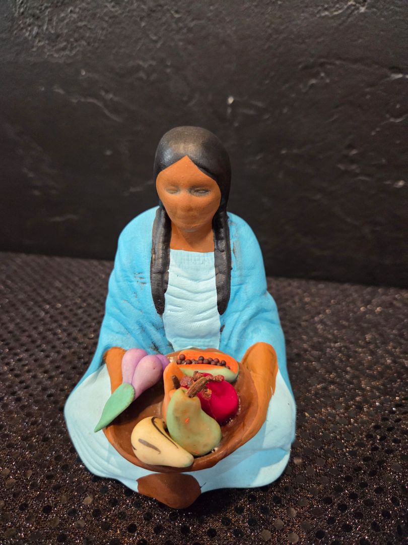 Southwestern Clay Woman holding a bowl of Fruit