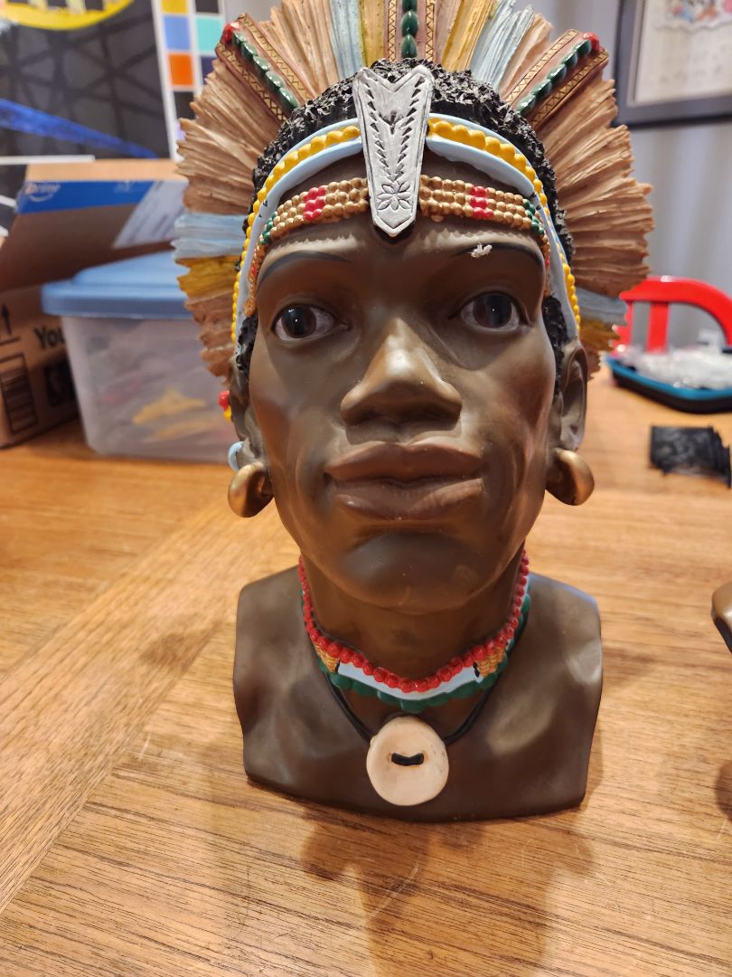 Mens Head sculpture with feathers