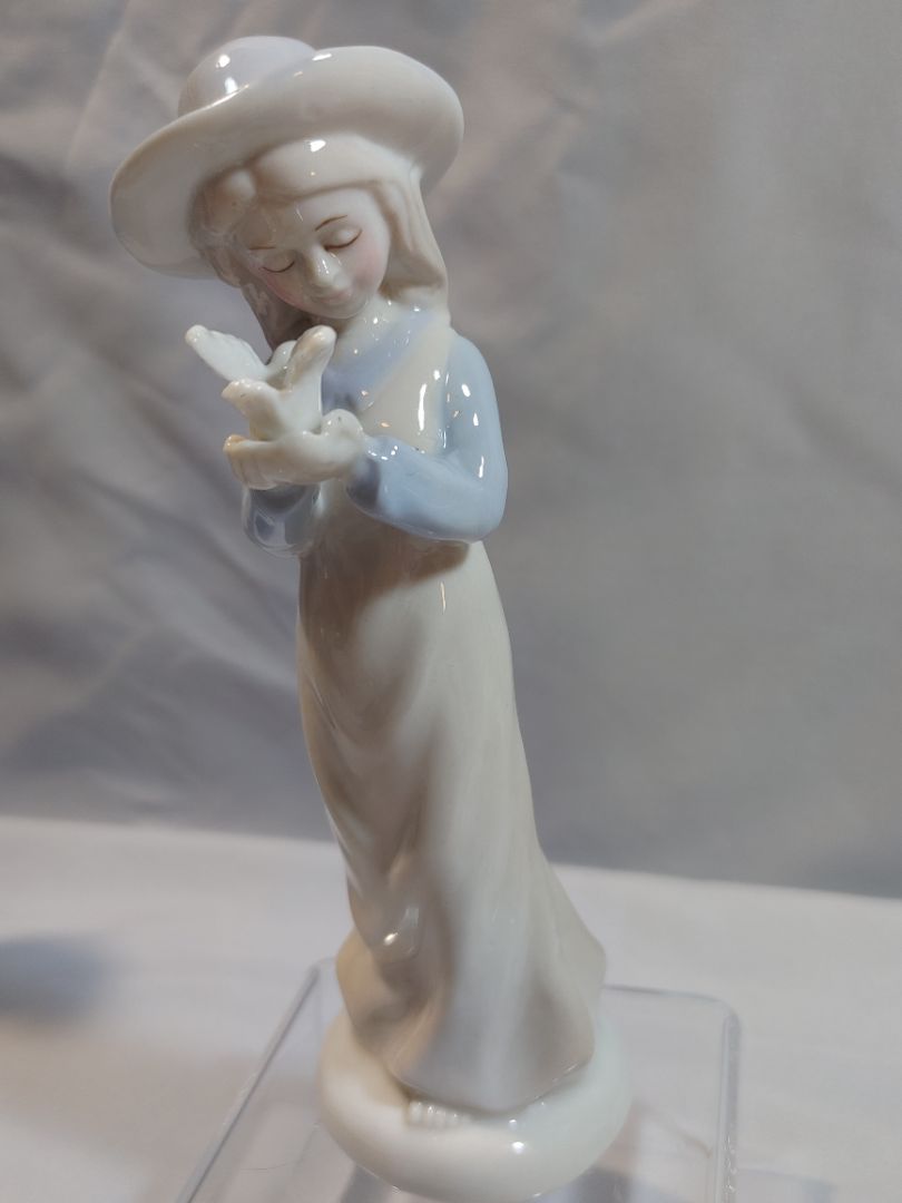 Porcelain Figurine girl holding dove & hat in blue top white skirt, 6.5"