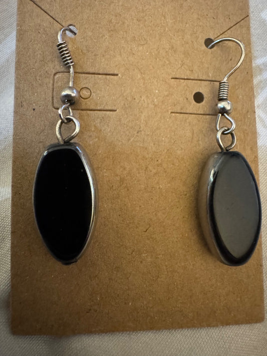 Black long oval silvertone dangle earrings