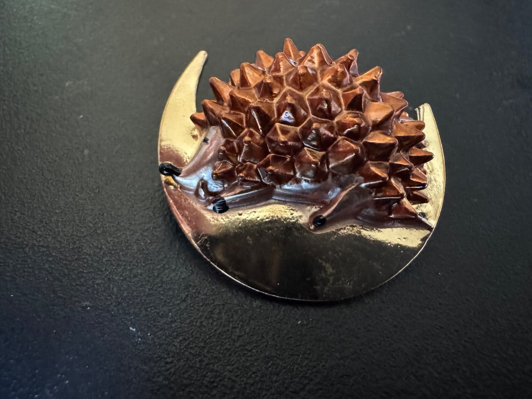 Hedgehog on goldtone moon brooch