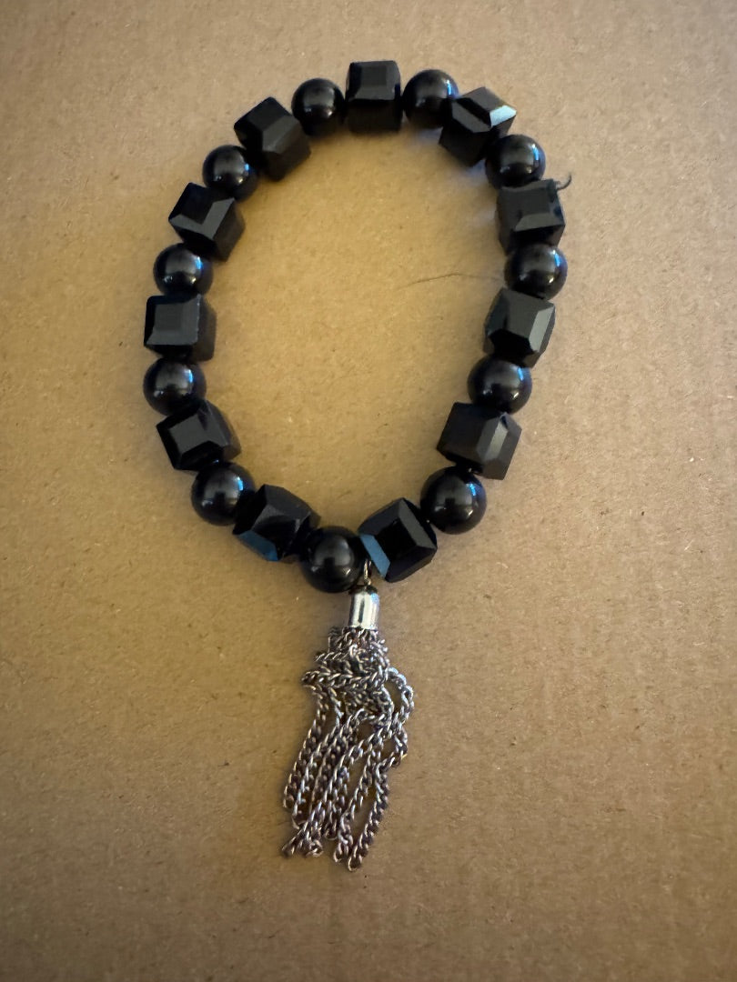 Black bead with silvertone tassel stretchy bracelet