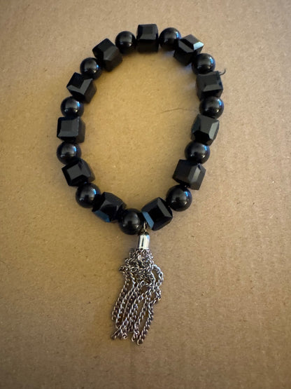Black bead with silvertone tassel stretchy bracelet