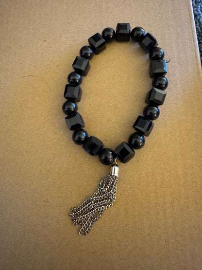 Black bead with silvertone tassel stretchy bracelet