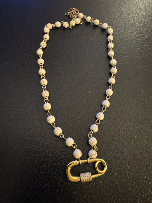White and Goldtone necklace with diaper hanging pendant