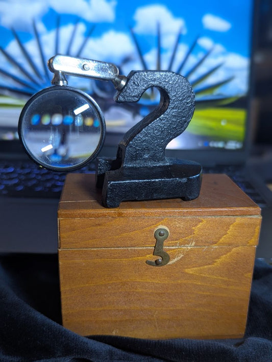 Vintage magnifyer with cast iron base and wood storage box