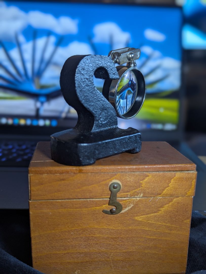Vintage magnifyer with cast iron base and wood storage box