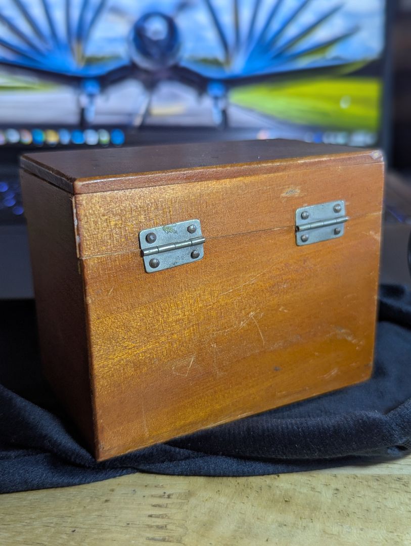 Vintage magnifyer with cast iron base and wood storage box