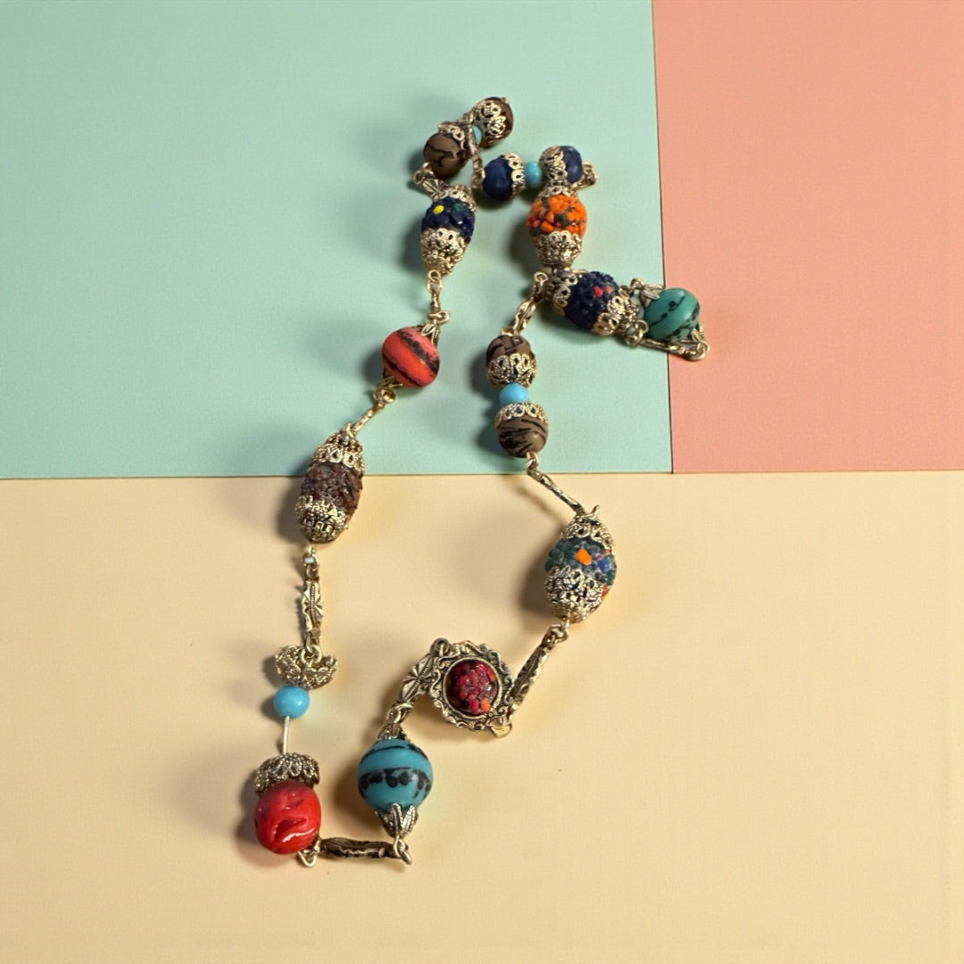 Multi color goldtone/cap double clasp necklace