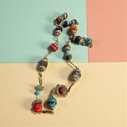 Multi color goldtone/cap double clasp necklace