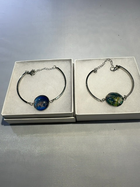 Multiple colors Luminous Creations Acrylic poured paint, skin stain, stainless steel bra bracelet, 3 inches X 3 inches