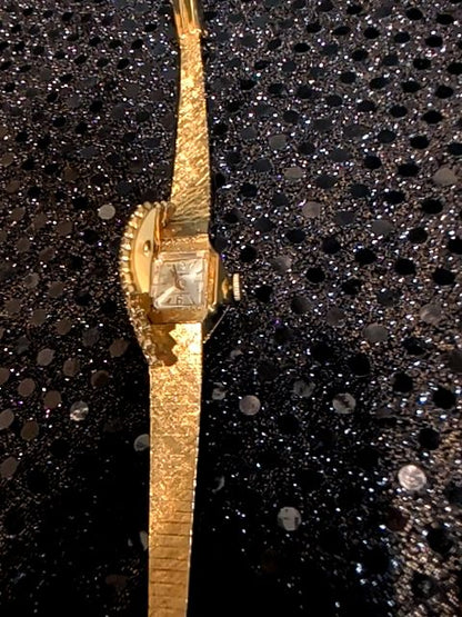 Ladies gold tone "Hidden Face" watch with rhinestones