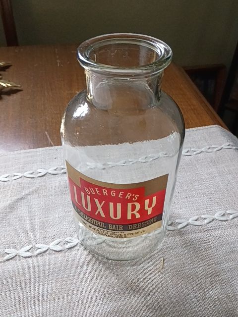 Large glass bottle of buergers luxury hair dressing 8.x 5