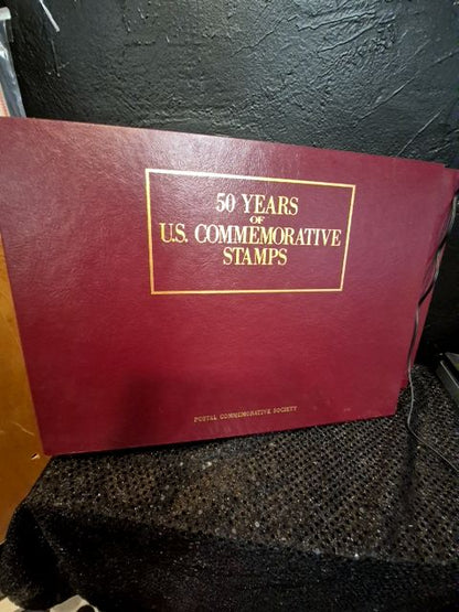 Burgandy United States Postal Service 50 Years of US Commemorative Stamps (2 Albums), 16" × 11.5"