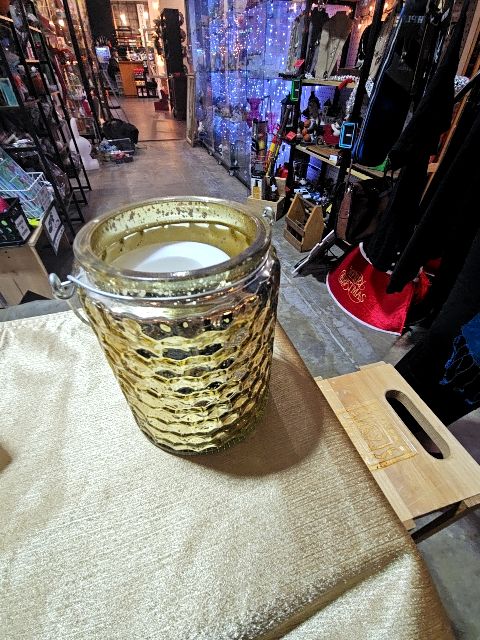 Gold jar with handle and candle