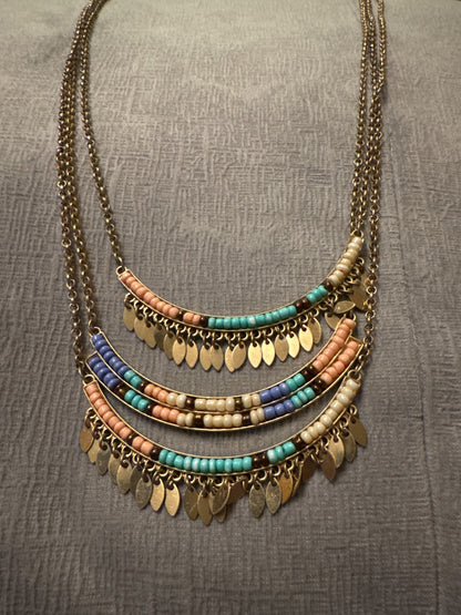 Gold tone setting, pastel beads Unknown Three bar, long, gold tone necklace
