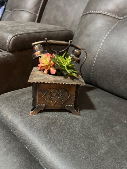 vintage upcycled or novelty metal telephone planter holding faux succulents.