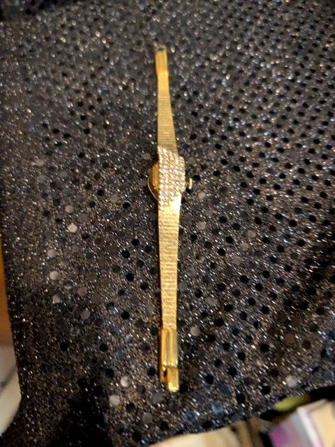 Ladies gold tone "Hidden Face" watch with rhinestones